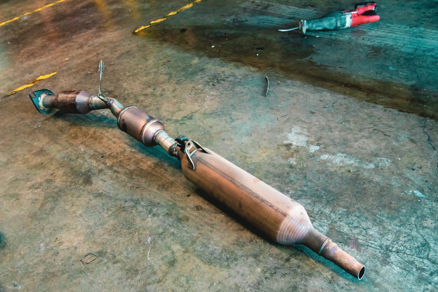 FILE PHOTO — A catalytic converter from a hybrid Prius is pictured next to an electric reciprocating hand saw.